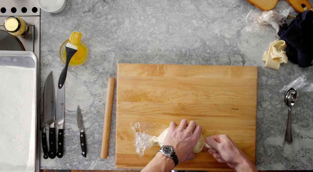 Gordon Ramsay twisting Beef Wellington in plastic wrap