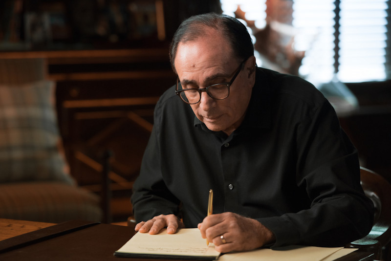 R.L. Stine writing at desk