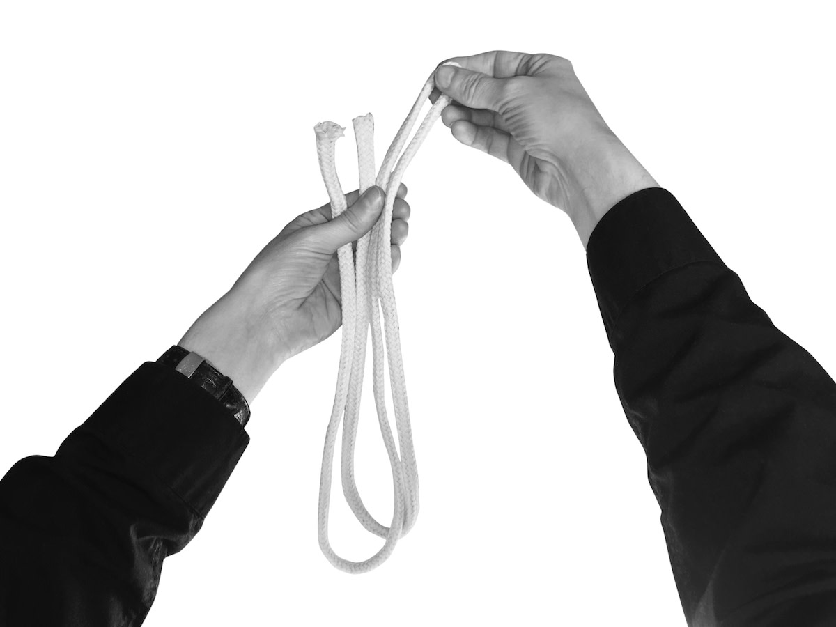 Person holding folded rope with both hands