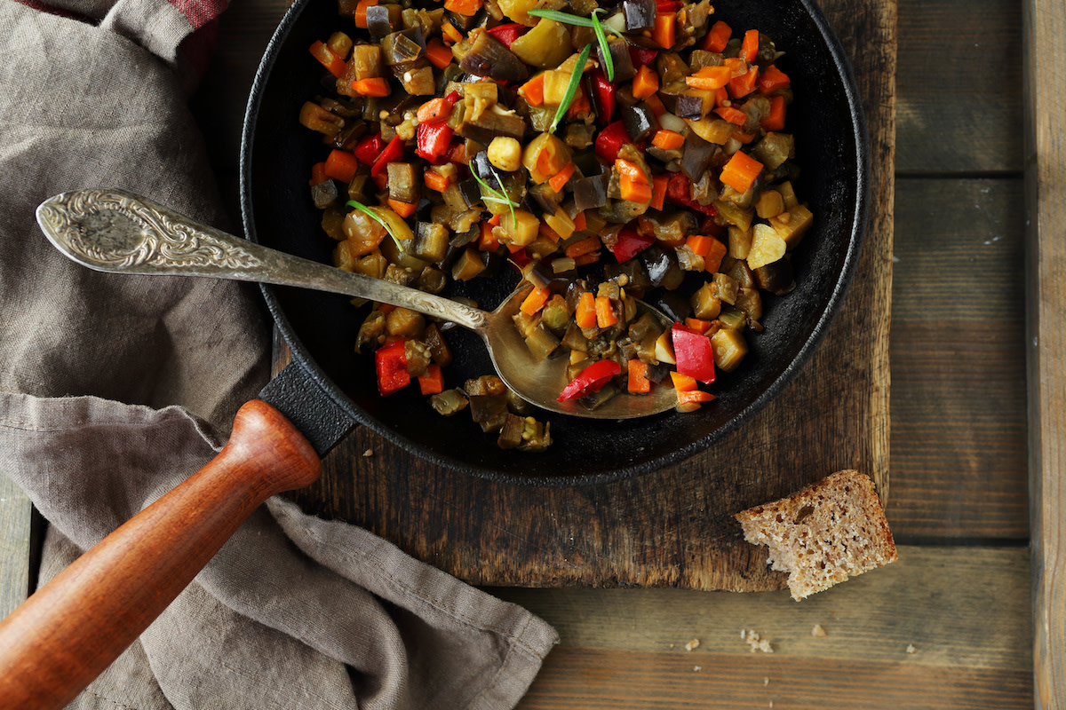 Ratatouille in pan on rustic wood with bread