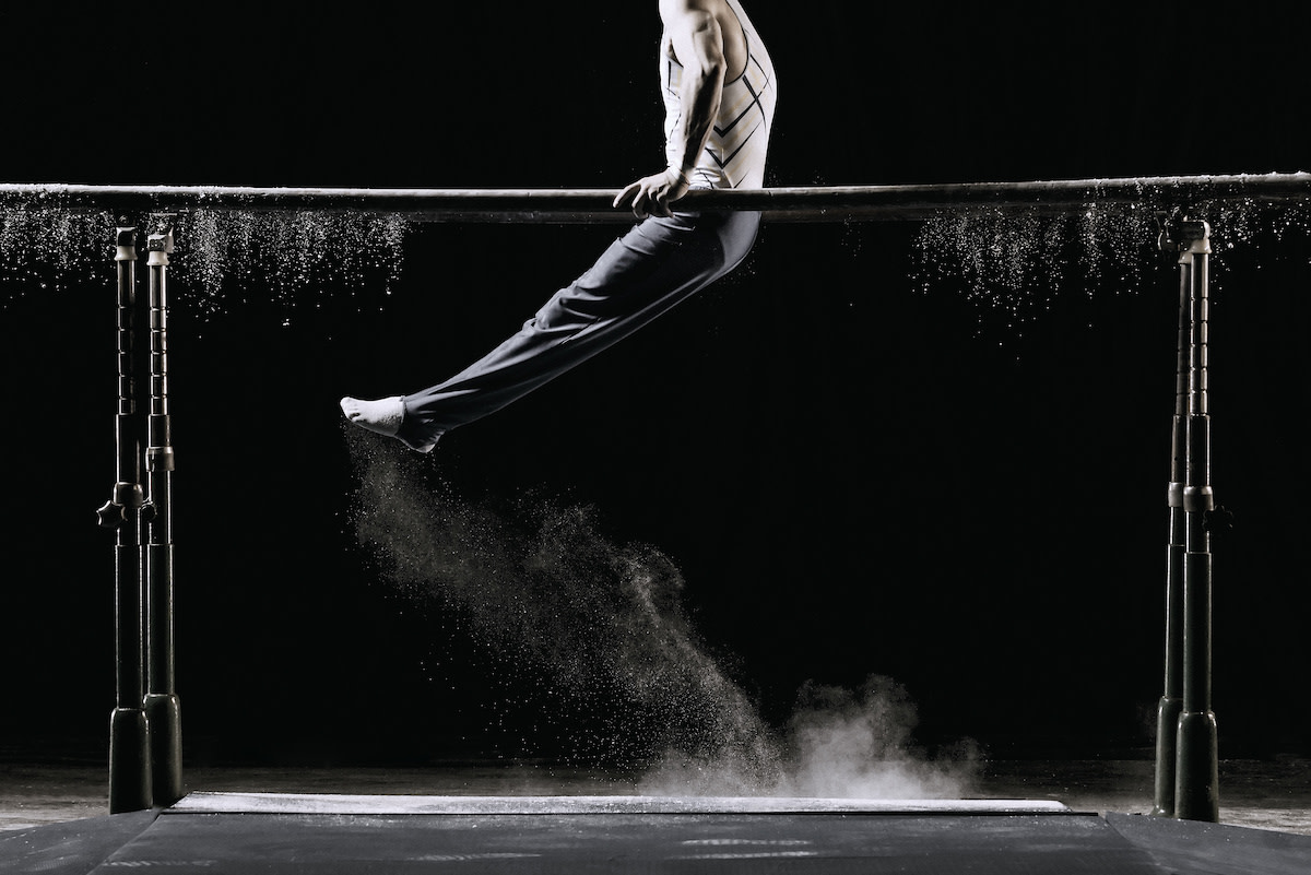 man on parallel bars in gymnastics