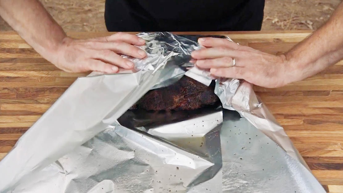 Aaron Franklin wrapping brisket in foil