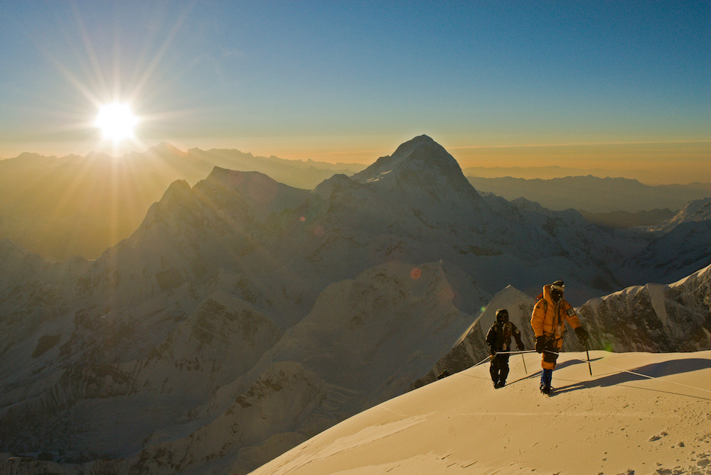 Jimmy Chin's portrait photograph of men hiking in a snowy mountain range