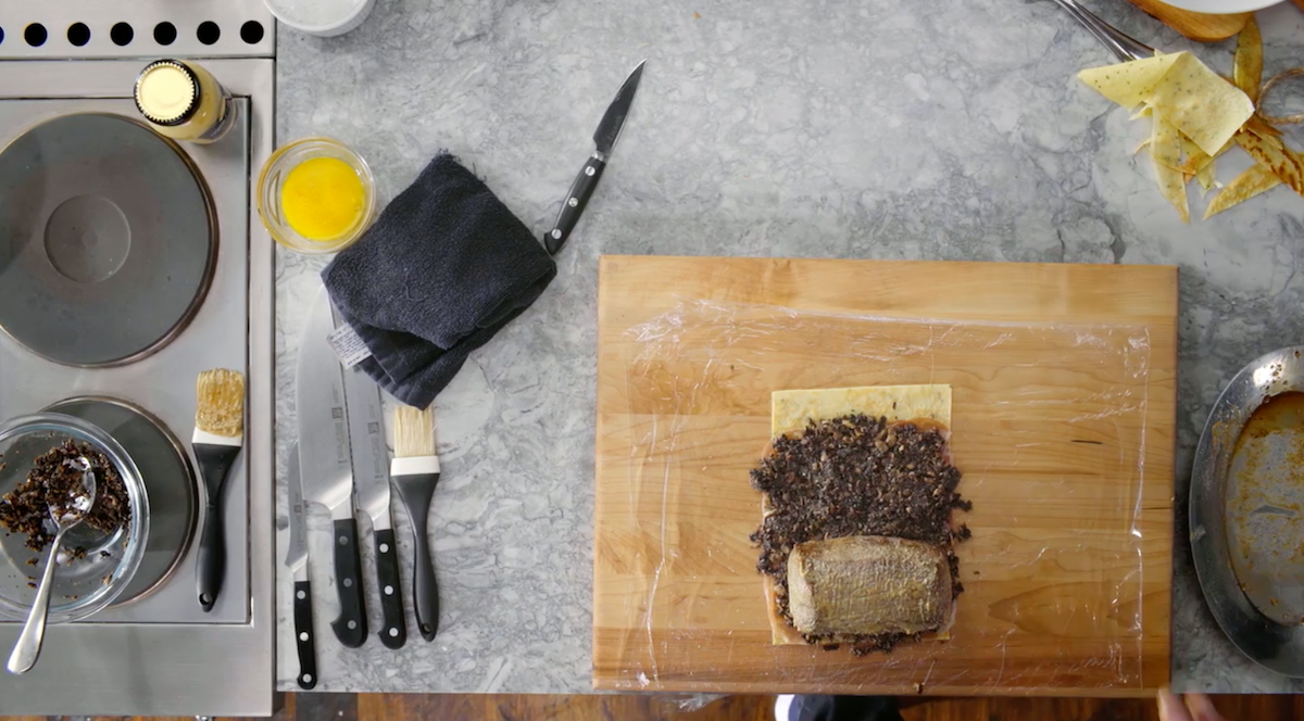 Beef Wellington assembly on cutting board