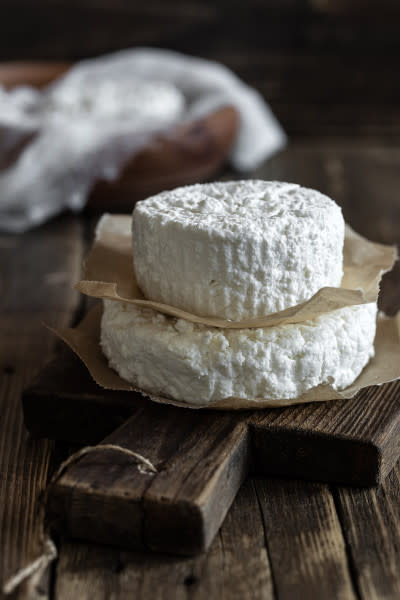 Soft cheese on cutting board