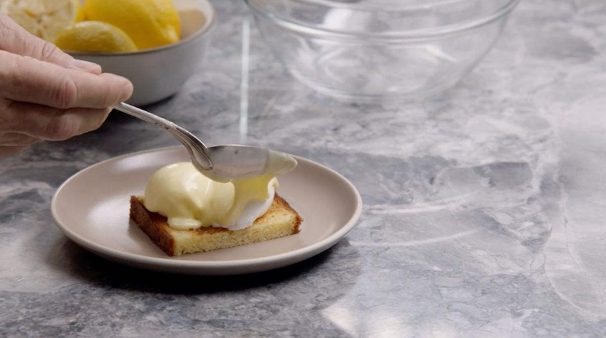 Chef Thomas Keller pouring hollandaise sauce over poached eggs