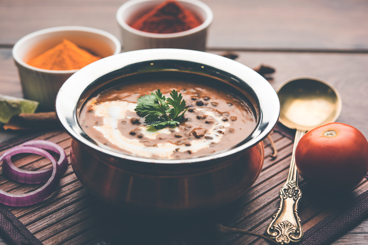 Dal Makhani in silver bowl with ingredients