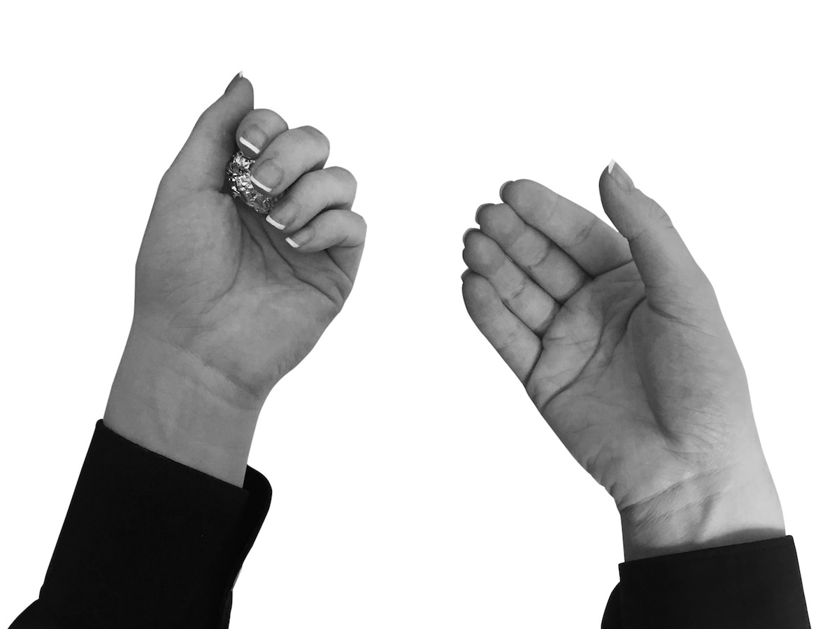 Woman's hands with tinfoil ball in left hand