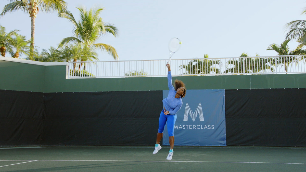 Serena Williams jumping and hitting tennis ball 