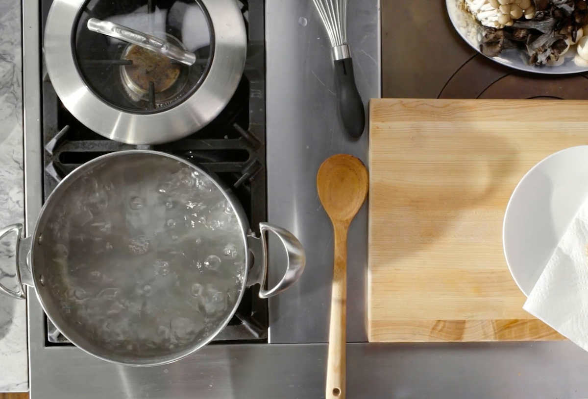 Boiling water on pot with cutting board