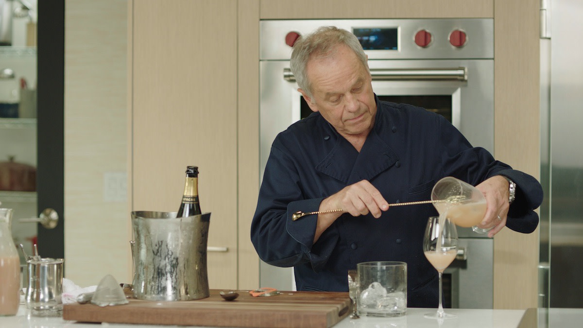 Wolfgang Puck pouring bellini in glass