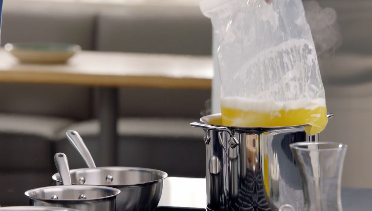 Melted butter in plastic bag being lifted out of pot