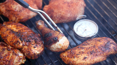 cooking pieces of chicken on a bbq