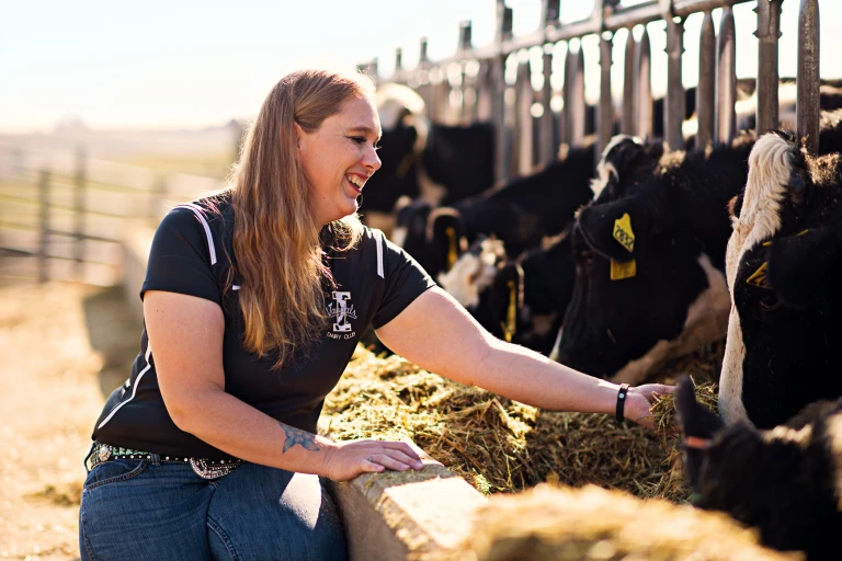 A Chobani employee feeding one of the company's cows to display how sustainable Chobani is