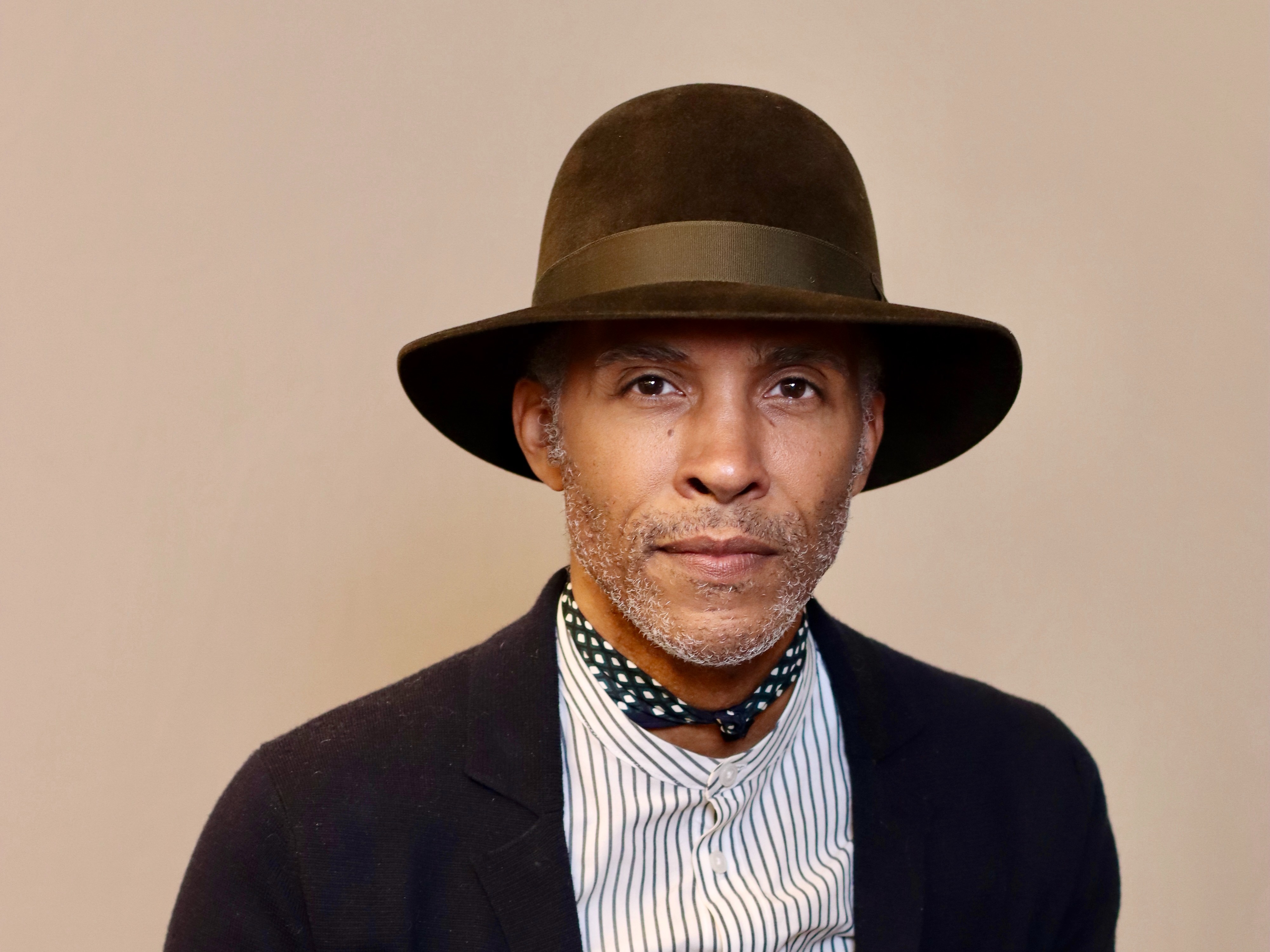 Ron Norsworthy poses in front of a solid background.