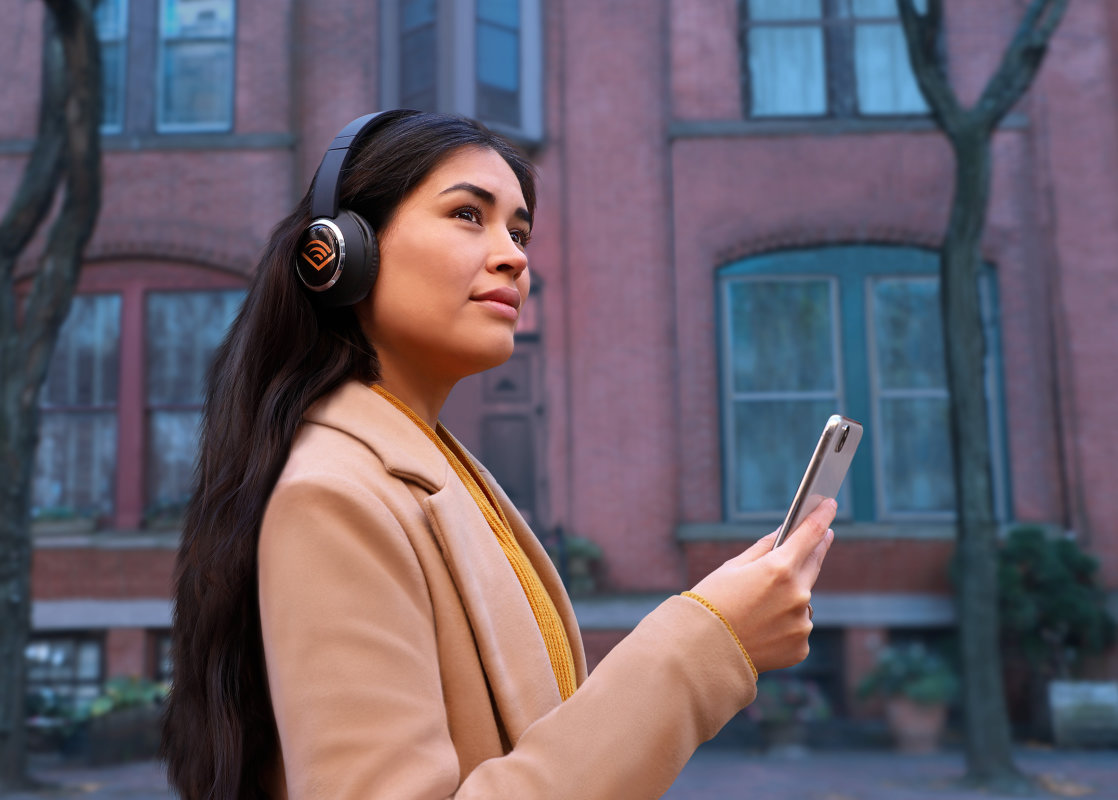Woman listens to Audible on a street in Newark