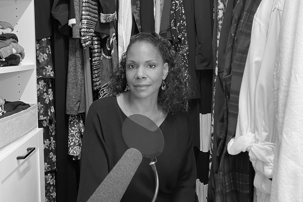 Actress Audra McDonald sits in her walk-in closet, a microphone propped in front of her, the clothes hanging around her helping to dampen the sound. Photo credit: Devin Oktar Yalkin/New York Times