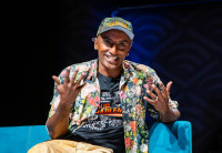 Chef Marcus Samuelsson on stage at Audible wearing an "Our Harlem" t-shirt.