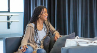 Proof of Love playwright and Newark native Chisa Hutchinson sits on a couch at her play's rehearsal.