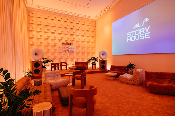 A photo of Audible Story House's Gallery room, which features comfy seating and vibrant lighting. 