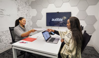 Two women meet in an Audible conference.