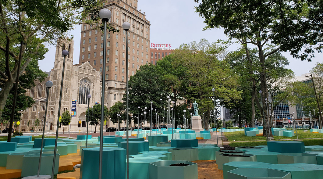 Blue hexagon seats, tables and planters and solar lights in Washington Park in Newark.