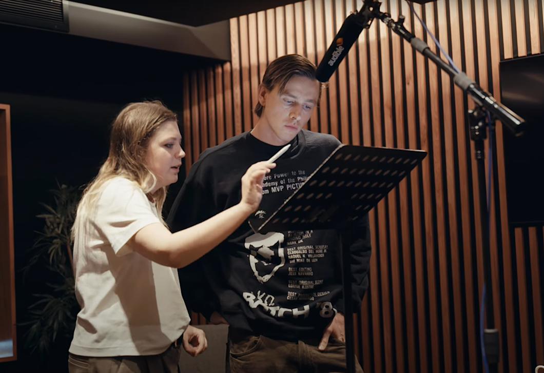 A photo of Lulu Raczka and Harris Dickinson going over lines of "Pride and Prejudice" in the studio. 