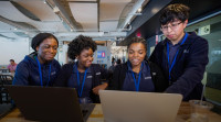 Edna Agyemang, Newark high school intern, working at Audible with her fellow interns.