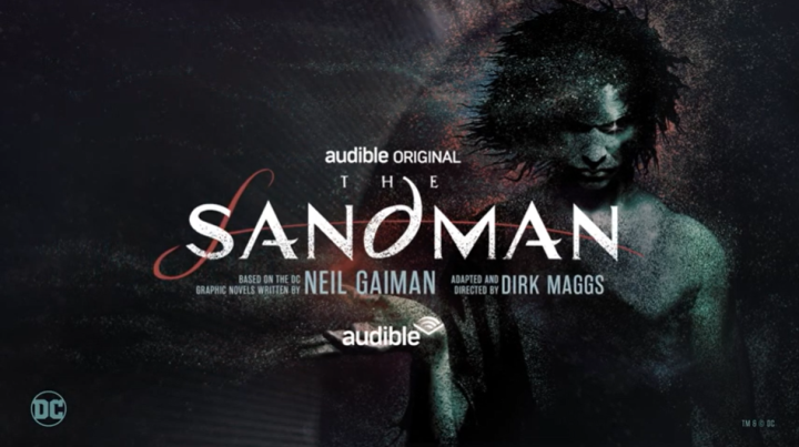 The cover art for the Audible Original series "The Sandman" shows the title character illustrated against a dark gray background. He has his head bent, his black hair thick and blowing in the wind. There is sand around him, in his hair, and blowing off his open palm which is held up next to him. Neil Gaiman and Dirk Maggs are credited in the cover art and DC's logo appears in the lower left corner.