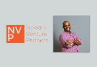 Newark Venture Partner's Managing Partner Vaughn Crowe stands in a purple and white checked shirt  against a grey backdrop. He's leaning back slightly with his arms crossed and is mid-laugh, grinning broadly. The left side of the image has NVP's logo.