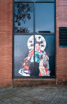 a windowfront with a collage of a woman