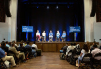 A panel of Audible employees speaks from the stage at the Innovation Cathedral to an audience.