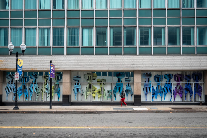 a storefront with persony colorful striped figures