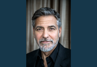 A headshot photo of actor, producer, and director George Clooney. He is looking directly at the camera. 