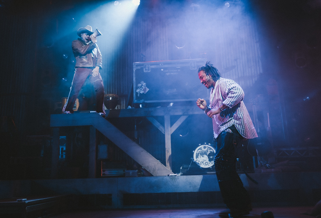 Brian Quijada and Nygel D. Robinson performing "Mexodus" onstage.