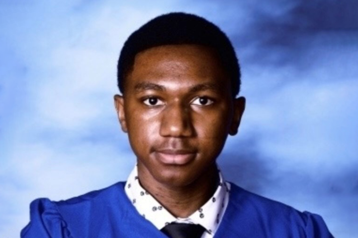 Achunike Okafor poses for a photo in his high school graduation gown.