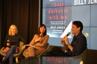 Author Billy Jensen seated on stage at Audible, mic in hand, in discussion with two Audible employees.