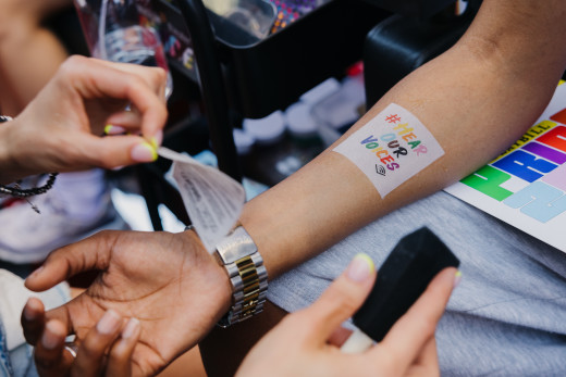 A temporary tattoo saying #HearOurVoices is applied to someone's arm. 