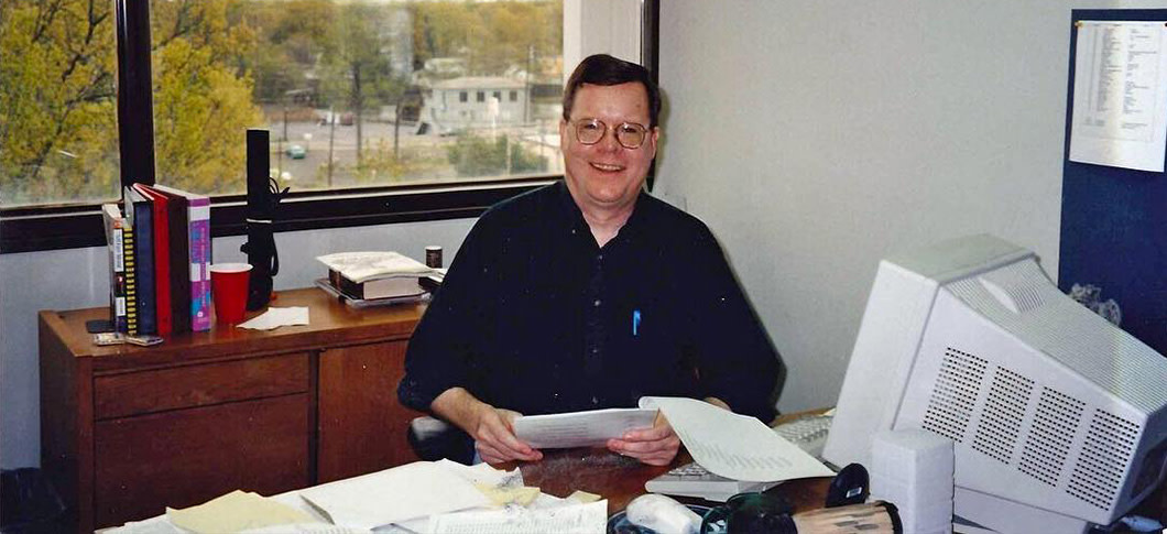 Rick Lewis at his desk in 1996