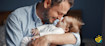 Father holds his child in his arms