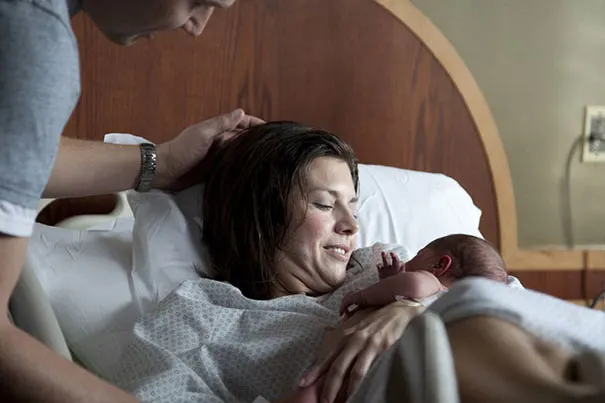 New mum holding her baby after childbirth. 