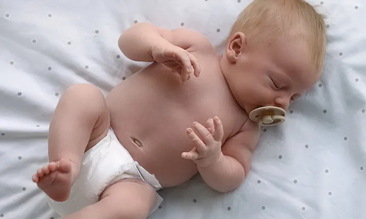 Newborn baby with a dummy