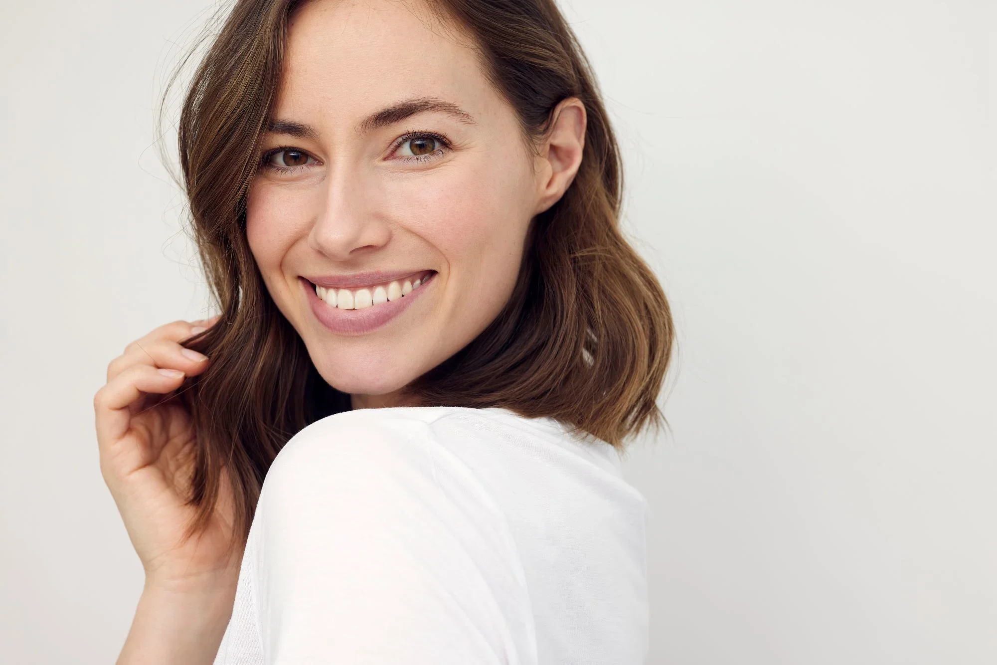 Woman smiling after learning how to whiten her teeth 