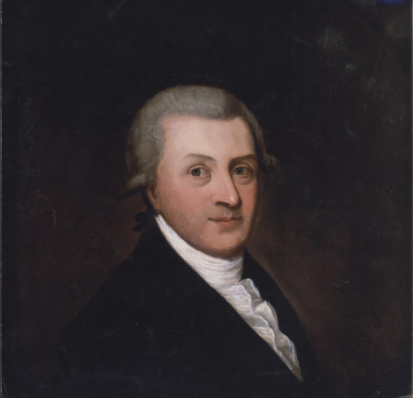 A formal portrait of a man with powdered hair, wearing a dark coat and a white cravat, looking slightly to the right against a dark background. 