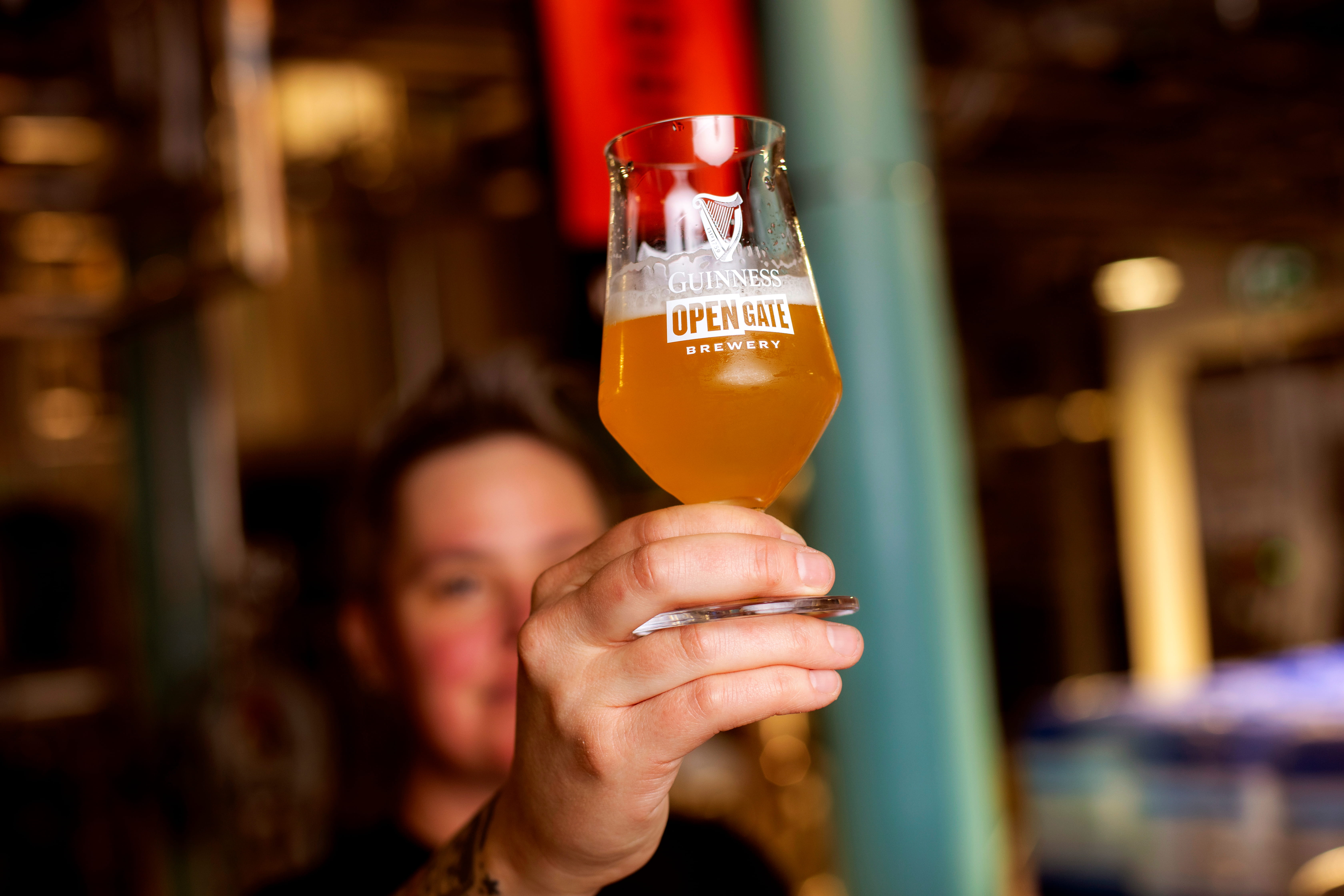 Hollie, the Master Brewer at Guinness Open Gate Brewery in London, inspects a freshly poured glass of craft beer in the brewery in central London.