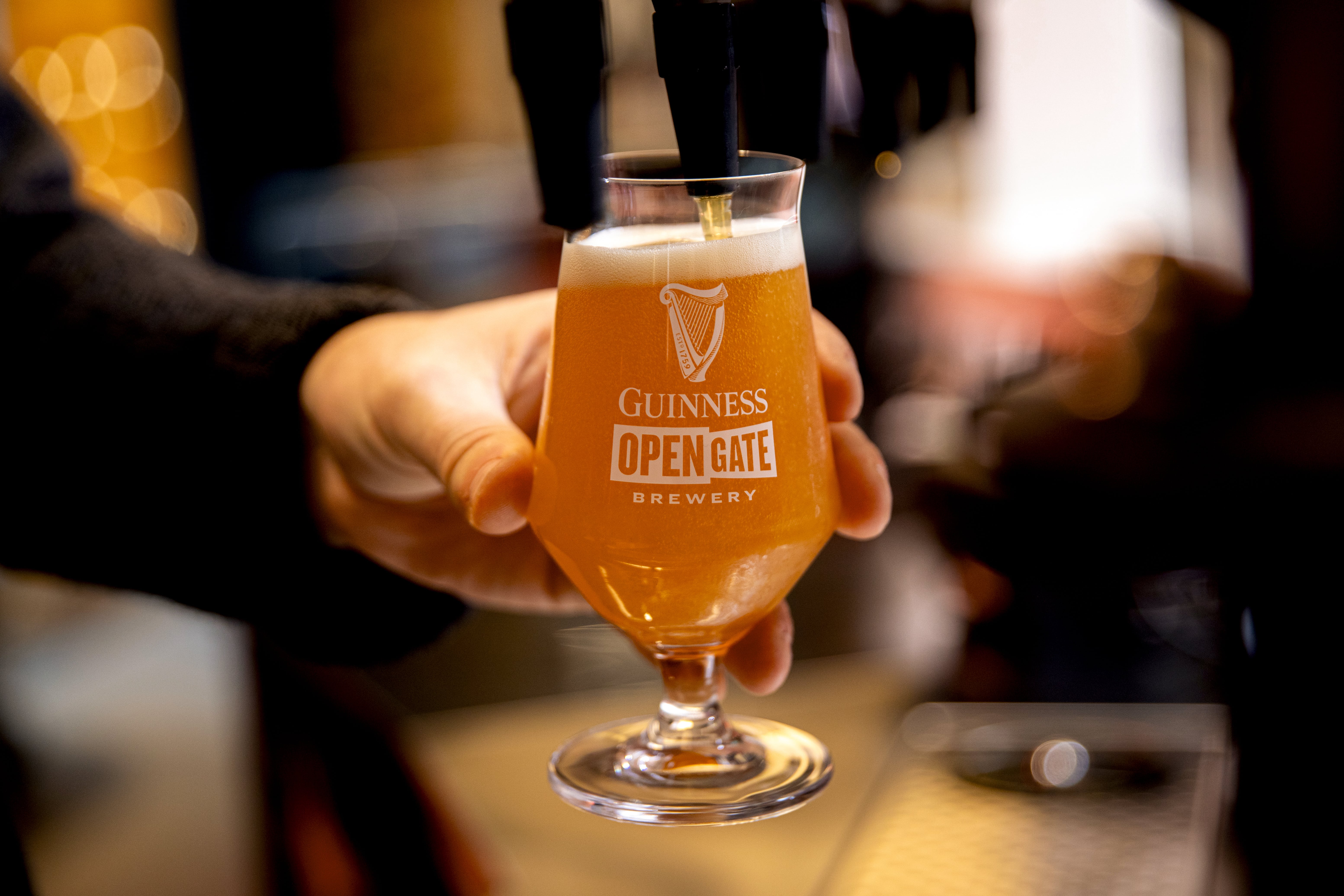 A craft beer is pulled from one of the taps in the Guinness Open Gate Brewery in London