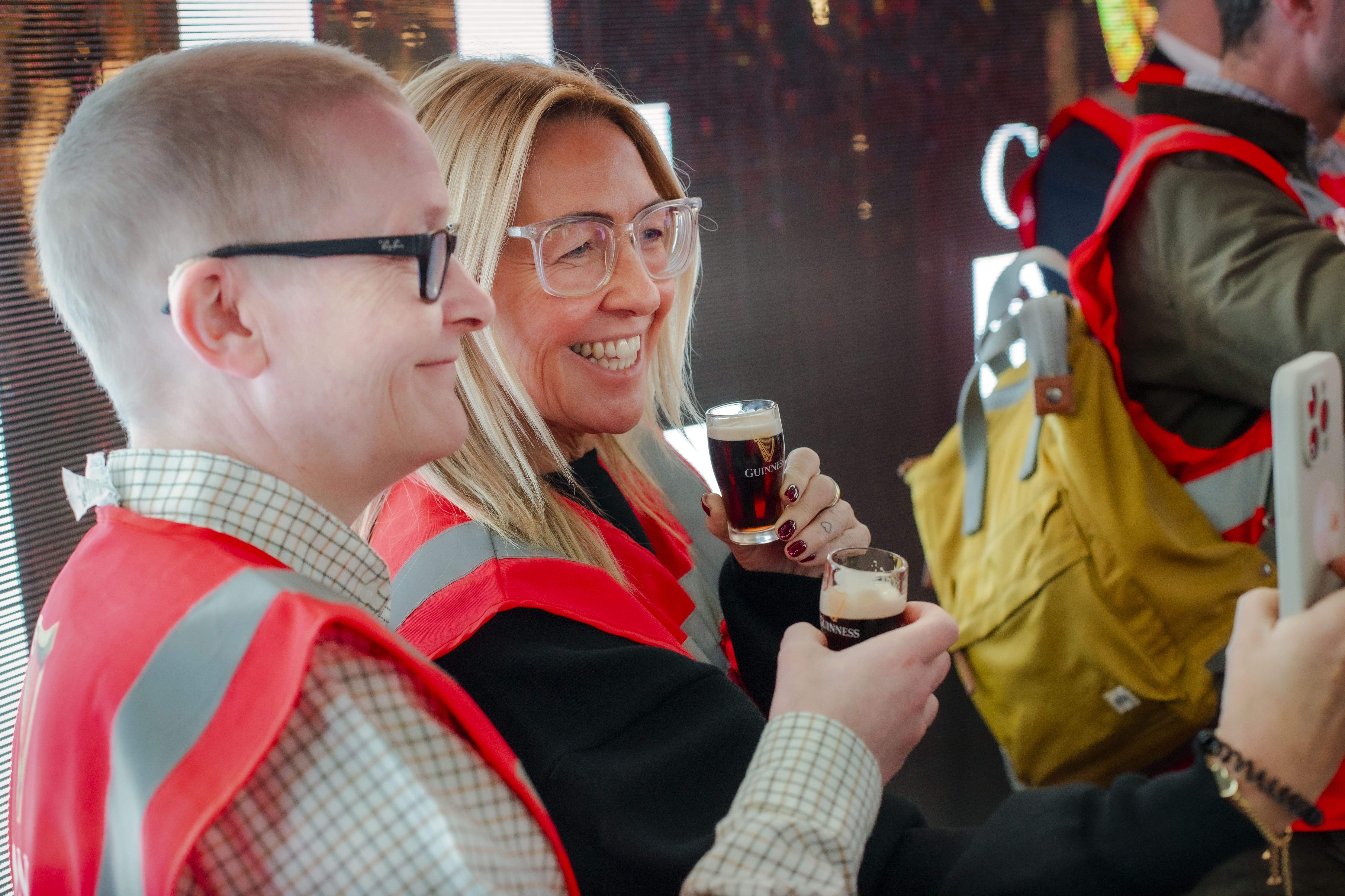 Two guests take a selfie as they enjoy a mini pint of Guinness on the Open Gate Experience tour in Covent Garden