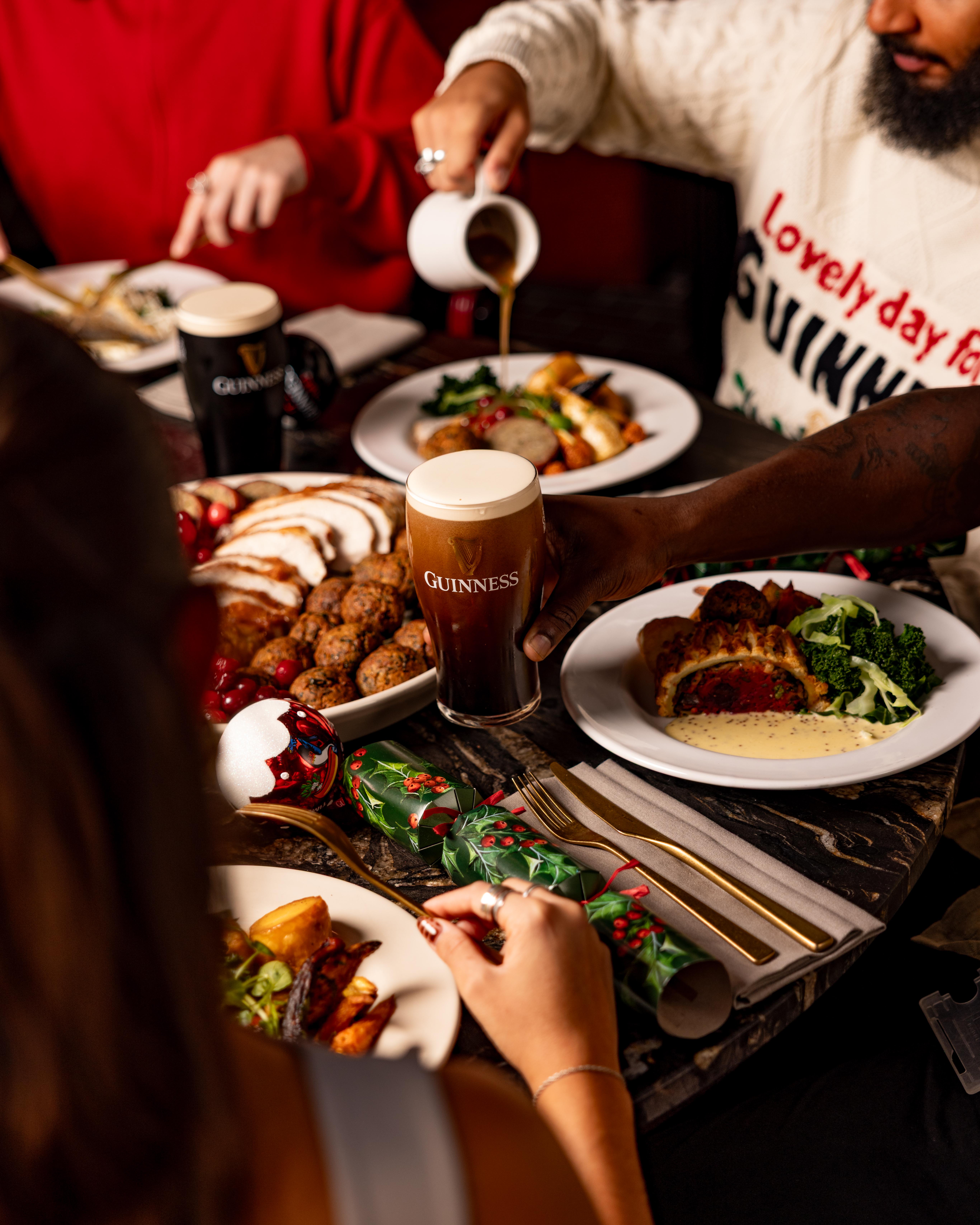 A festive table filled with turkey dinner and all the trimmings, with lashings of gravy and pints Guinness