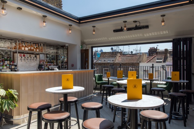 The top floor of Marquess of Anglesey has a retractable roof that lets the sun pour into the room, with it's own private bar.