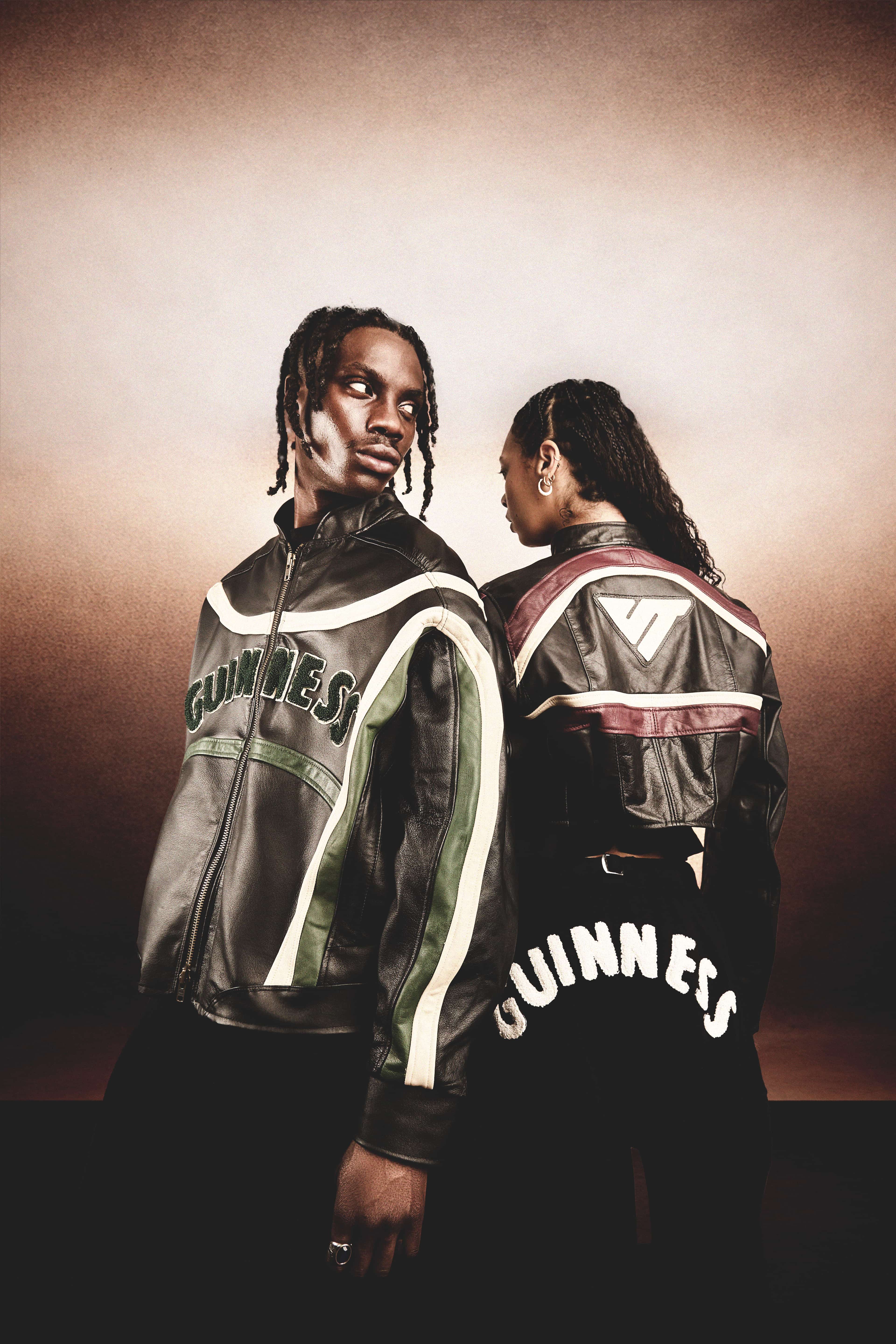 Two people model the Vintage Threads x Guinness collection, including black, green, and ruby red leather jackets and reworked vintage pieces.